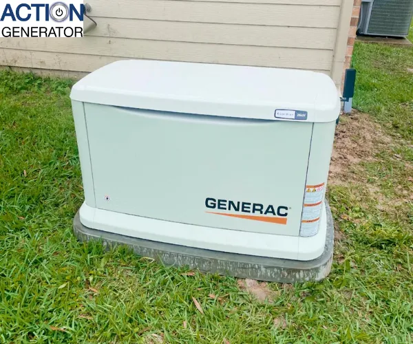 A close-up of a standby home generator installed on a concrete pad next to an exterior brick wall.